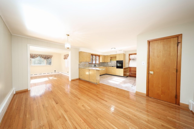 unfurnished living room with a baseboard radiator, light hardwood / wood-style flooring, and sink