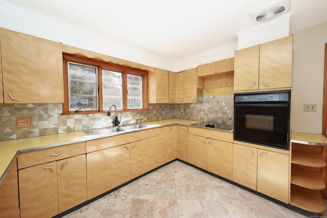 kitchen with tasteful backsplash, light brown cabinetry, sink, and black appliances