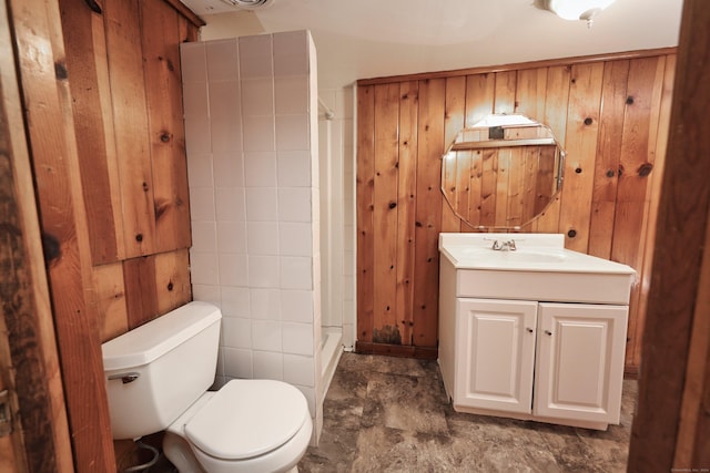 bathroom featuring vanity, toilet, walk in shower, and wooden walls