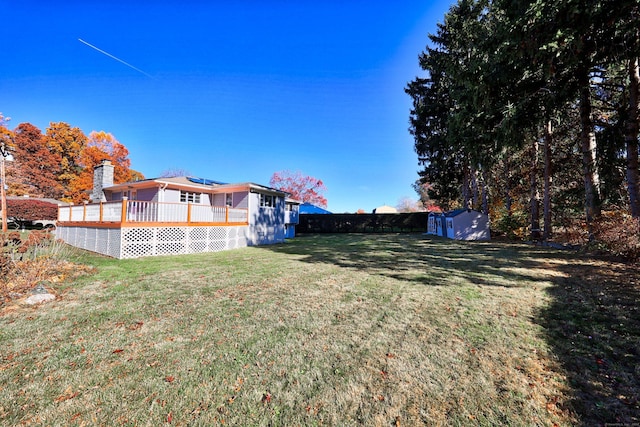 view of yard with a shed and a wooden deck