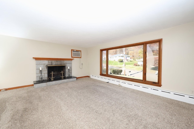 unfurnished living room with carpet, a stone fireplace, a wall mounted AC, and a baseboard heating unit