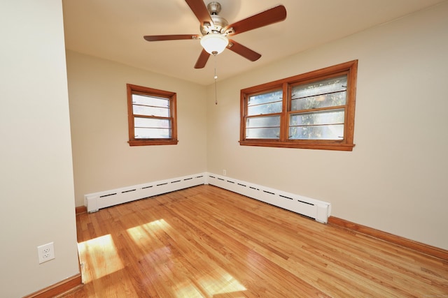 empty room with baseboard heating, ceiling fan, and light wood-type flooring