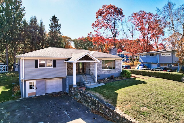 view of front of home featuring a garage and a front lawn