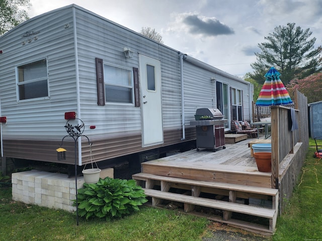 wooden terrace featuring grilling area