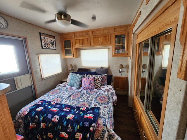 bedroom with dark wood-type flooring and ceiling fan