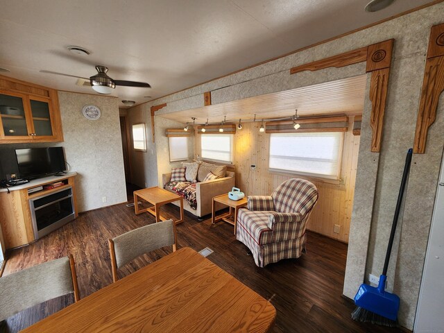 interior space with dark wood-type flooring and ceiling fan