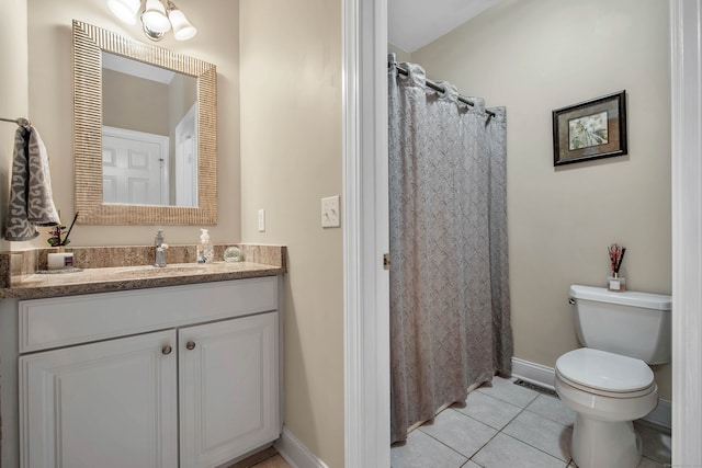 bathroom with vanity, walk in shower, tile patterned floors, and toilet