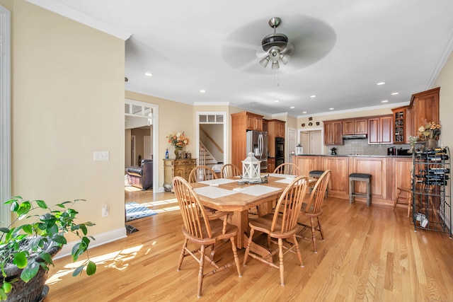 dining room featuring ceiling fan, light hardwood / wood-style flooring, and ornamental molding