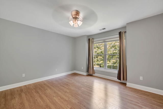 spare room with light hardwood / wood-style floors and ceiling fan