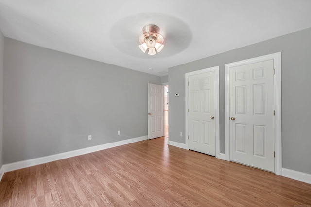 unfurnished bedroom with light wood-type flooring and ceiling fan