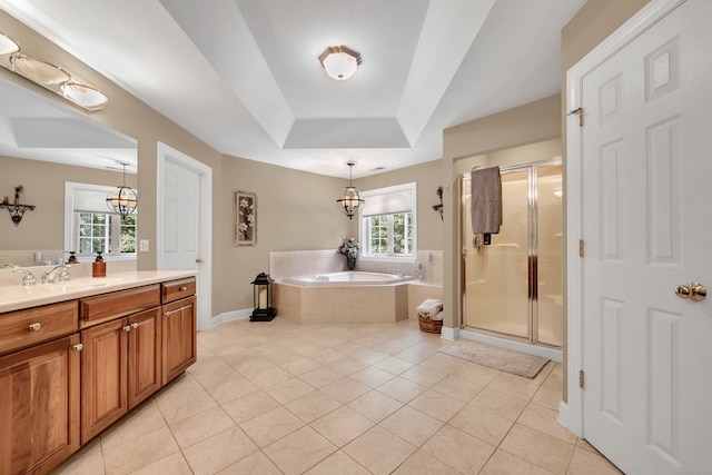 bathroom with a raised ceiling, vanity, tile patterned flooring, shower with separate bathtub, and a chandelier