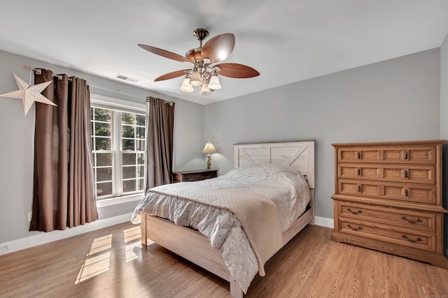 bedroom with light hardwood / wood-style floors and ceiling fan