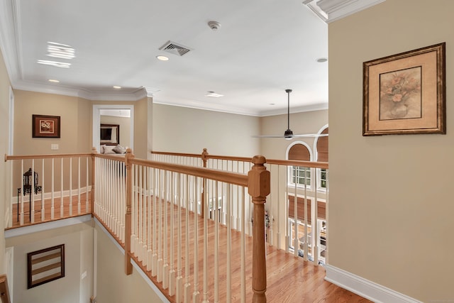 hall with ornamental molding and hardwood / wood-style floors