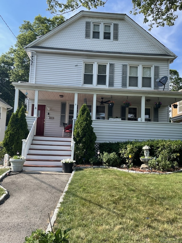 view of front of home featuring covered porch and a front yard