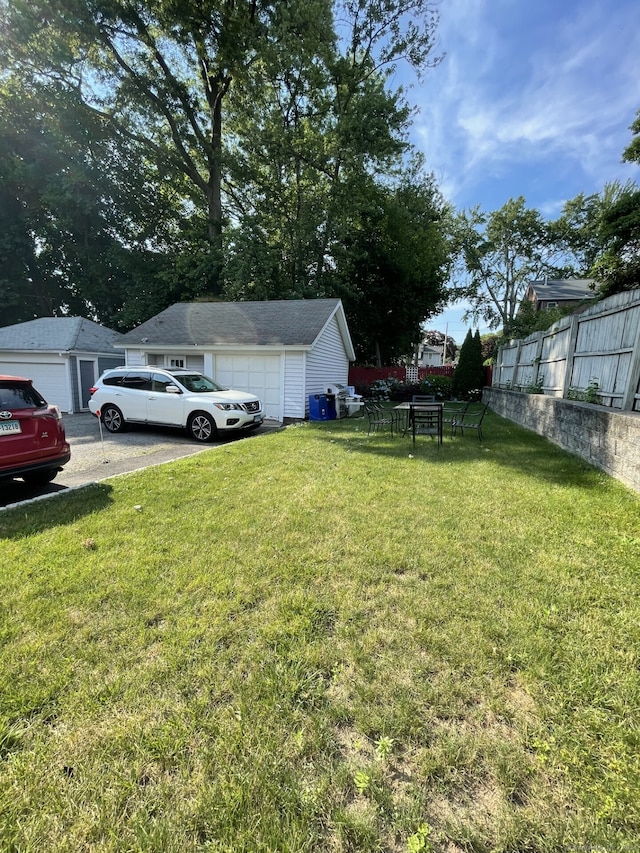 view of yard with a garage and an outdoor structure