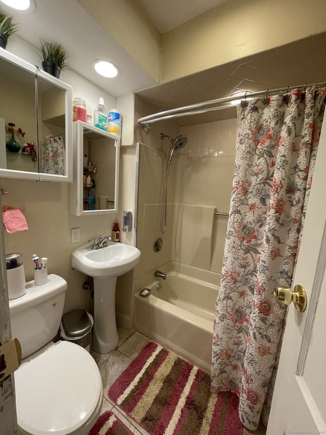 bathroom featuring toilet, shower / bath combo with shower curtain, and tile patterned flooring