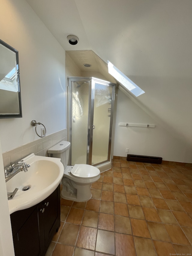 bathroom featuring toilet, vanity, walk in shower, and tile patterned floors