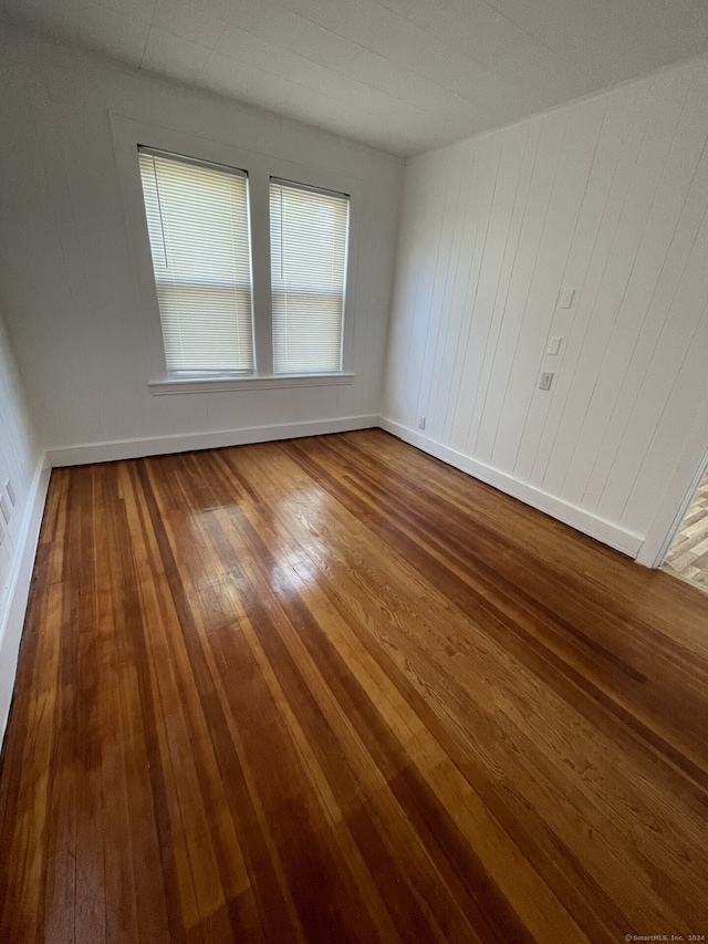 unfurnished room with wood-type flooring