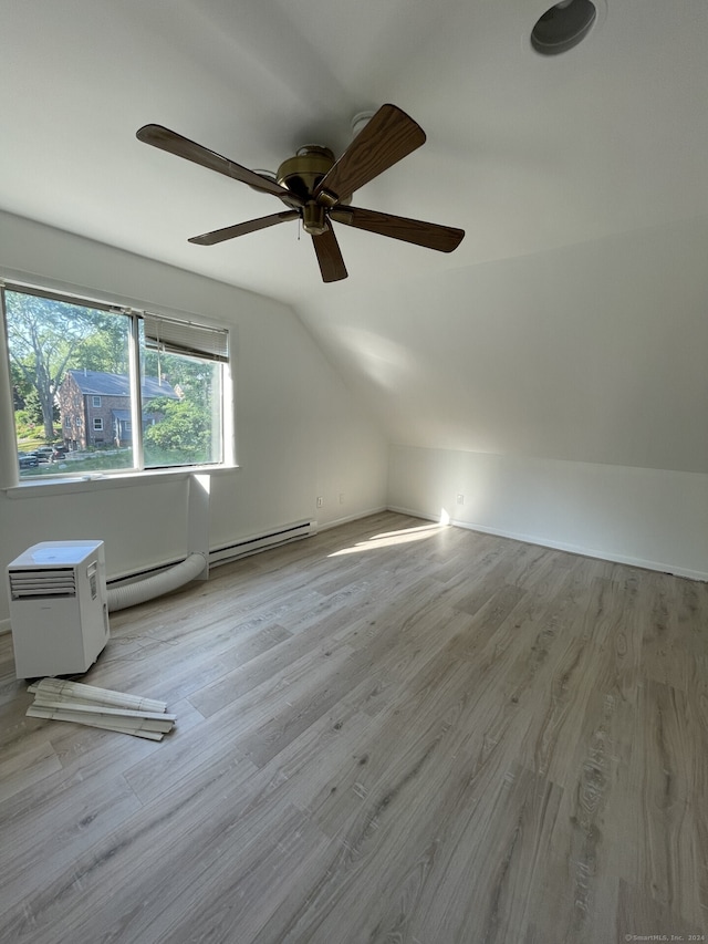 bonus room with ceiling fan, light hardwood / wood-style flooring, baseboard heating, and lofted ceiling