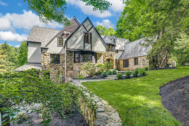 english style home with a front yard