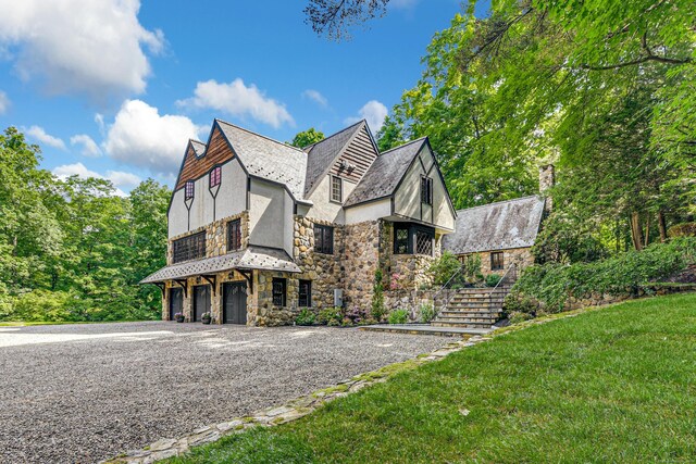 view of side of property with a lawn