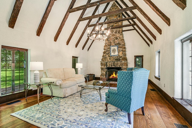 living room with beam ceiling, a stone fireplace, wood-type flooring, and high vaulted ceiling