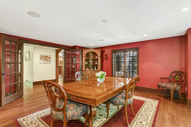 dining room with wood-type flooring and french doors