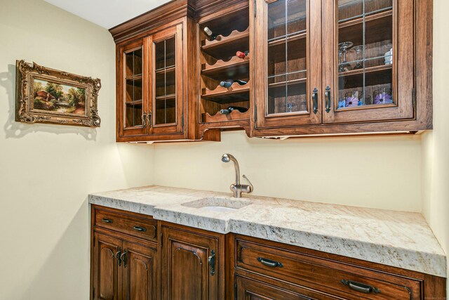 kitchen with sink and light stone countertops