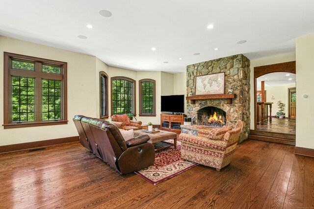 living room featuring a fireplace and dark hardwood / wood-style floors