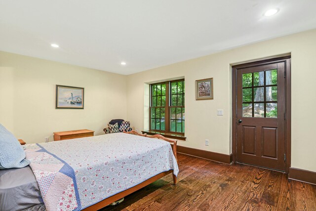 bedroom with dark wood-type flooring