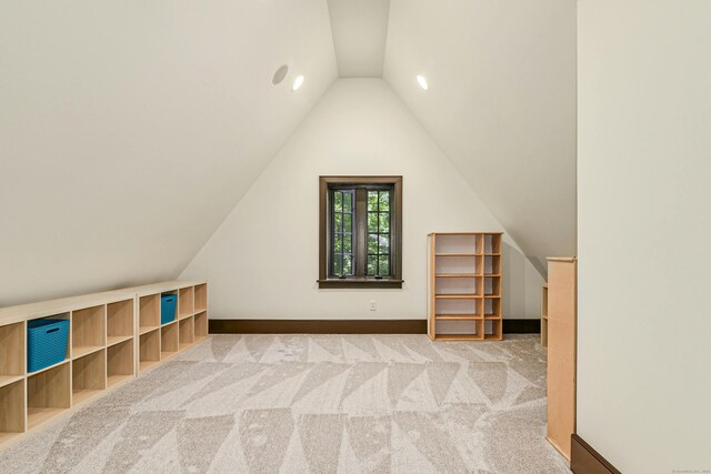 additional living space with lofted ceiling and carpet