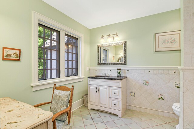 bathroom featuring vanity, tile patterned floors, and toilet