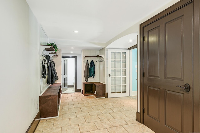 hall featuring light tile patterned flooring