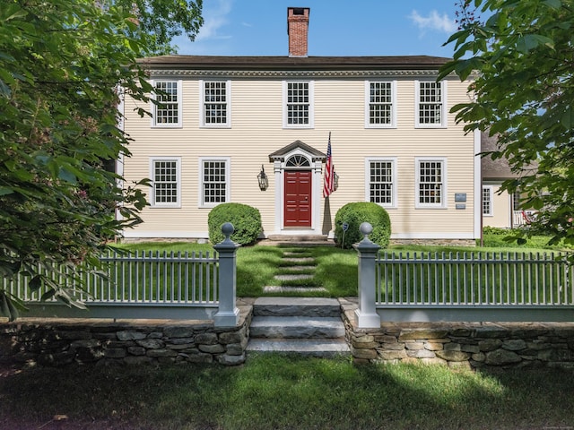 colonial home featuring a front yard