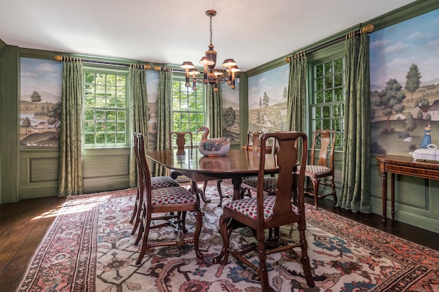 dining space featuring an inviting chandelier and hardwood / wood-style flooring