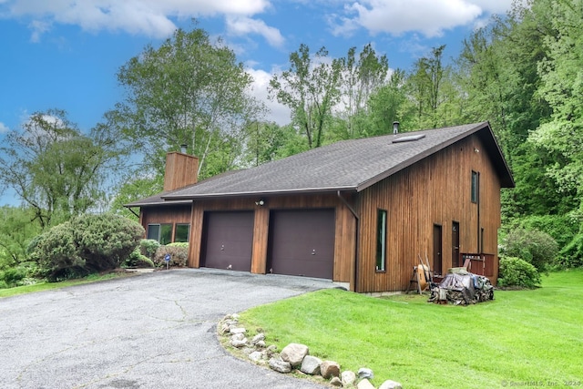 view of home's exterior with a yard and a garage