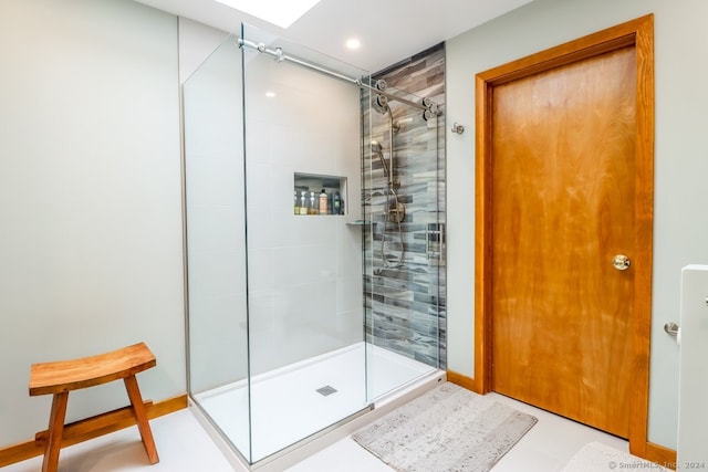 bathroom featuring a shower with door