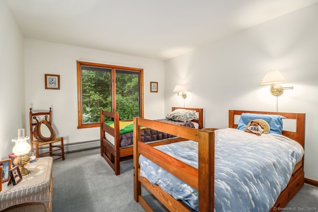 bedroom with carpet floors and a baseboard heating unit