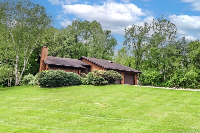 view of front facade with a garage and a front lawn