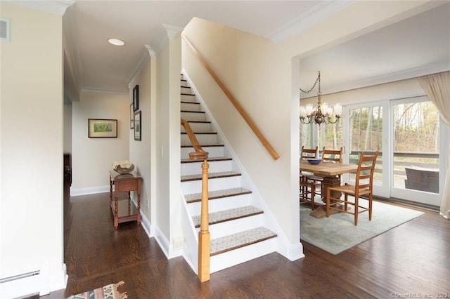 stairs featuring an inviting chandelier, dark hardwood / wood-style flooring, a baseboard heating unit, and crown molding