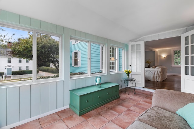 sunroom featuring vaulted ceiling