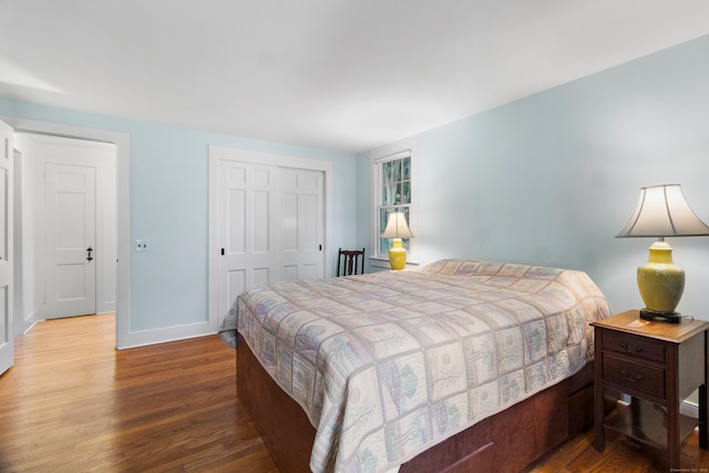 bedroom with hardwood / wood-style flooring and a closet