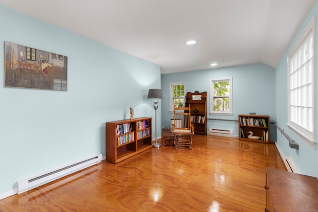 sitting room featuring a baseboard radiator, lofted ceiling, and hardwood / wood-style floors