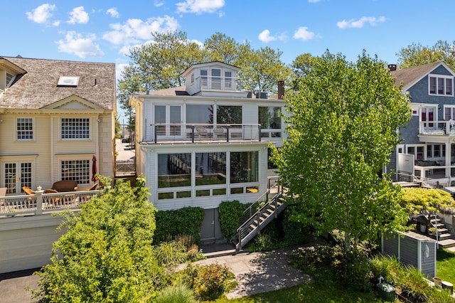 rear view of property featuring a balcony