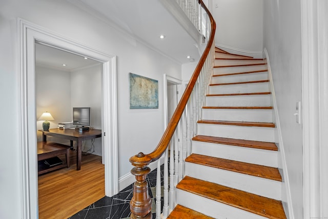 stairway featuring hardwood / wood-style flooring and ornamental molding