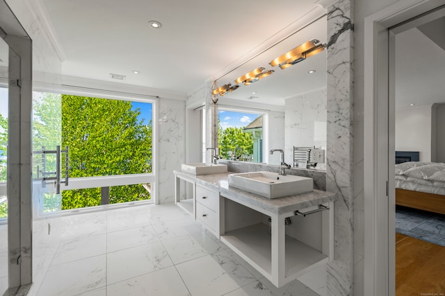 bathroom with vanity, hardwood / wood-style flooring, and crown molding