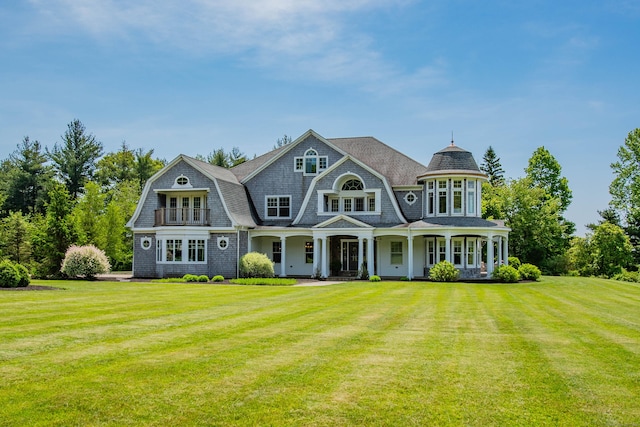 back of house with a lawn