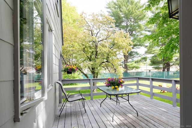 wooden deck featuring a yard