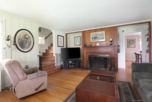 living room with hardwood / wood-style floors and a brick fireplace