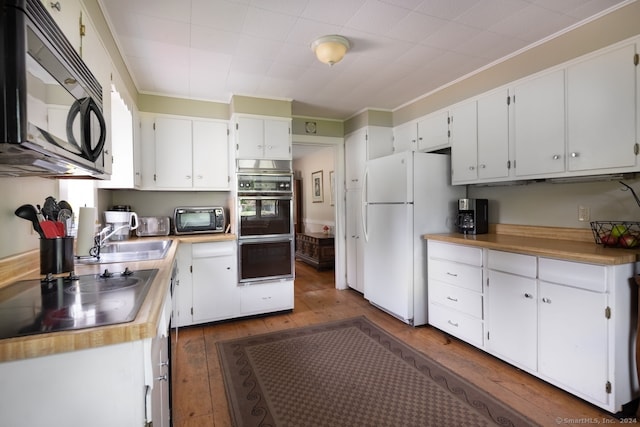 kitchen with dark hardwood / wood-style flooring, white cabinets, and black appliances